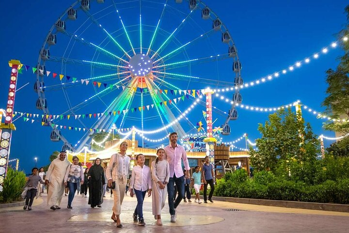 Immerse yourself in the lively ambiance of Bollywood™ Dubai where families stroll under twinkling lights surrounded by exhilarating rides and the enchanting charm of India's film industry.